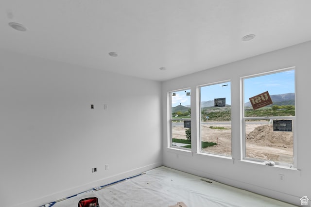 unfurnished room featuring baseboards