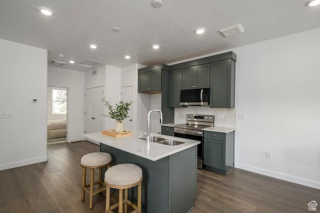 441 N Bishop Pl Unit 4-17, Salt Lake City, UT 84103 - kitchen featuring appliances with stainless steel finishes, a sink, baseboards, dark wood-style floors, and a textured ceiling