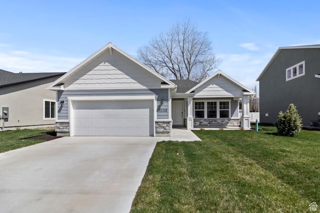 view of front of house featuring a garage, driveway, a front yard, stone siding, and covered porch