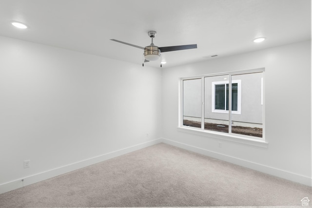 carpeted spare room with baseboards, a ceiling fan, and recessed lighting