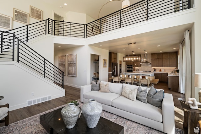 1015 W Sugar Maple Dr, Mapleton, UT 84664 - living room featuring dark wood-style flooring, stairs, baseboards, a high ceiling, and recessed lighting