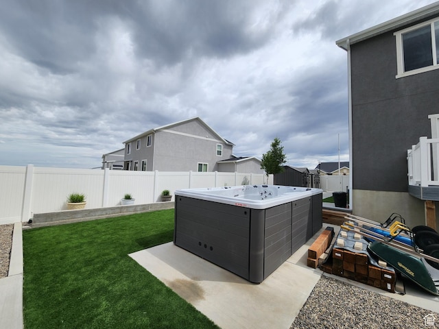 view of yard with a hot tub and a residential view