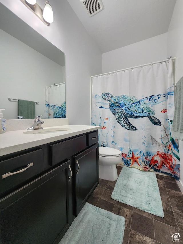 full bathroom with vanity, toilet, and vaulted ceiling