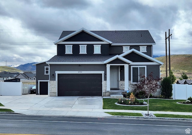 view of front facade featuring stucco siding, an attached garage, stone siding, and driveway