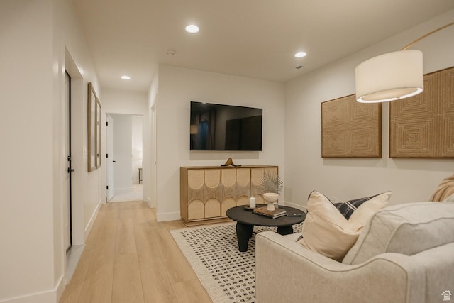 living room featuring wood finished floors, recessed lighting, and baseboards