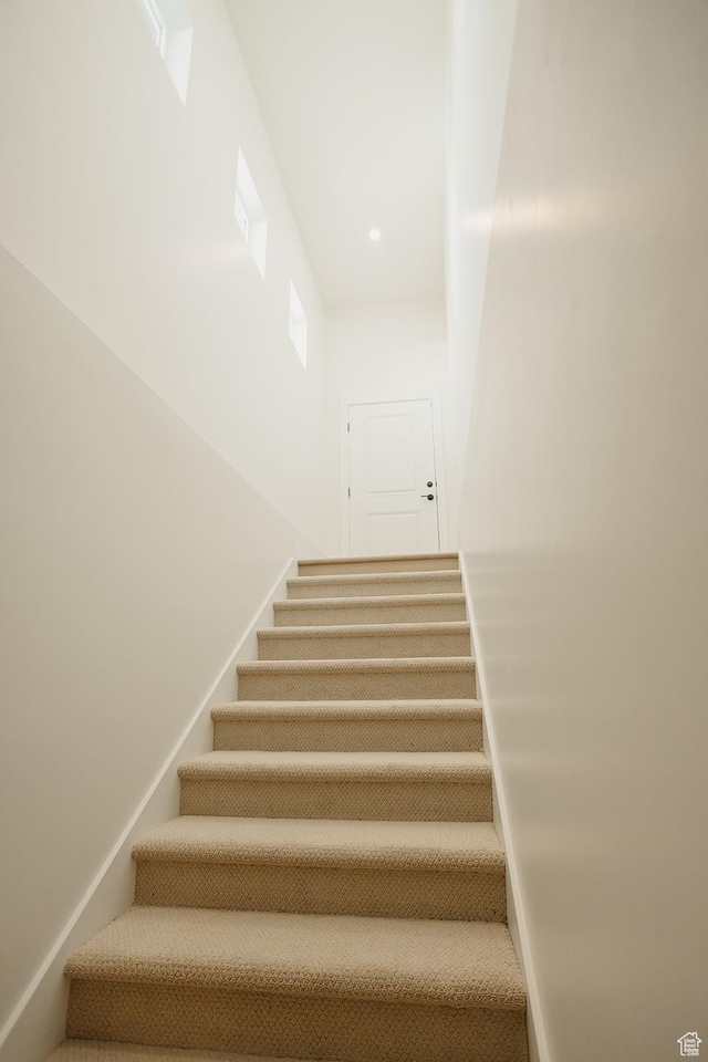 staircase with recessed lighting