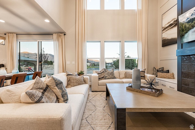 living area featuring a high ceiling and recessed lighting