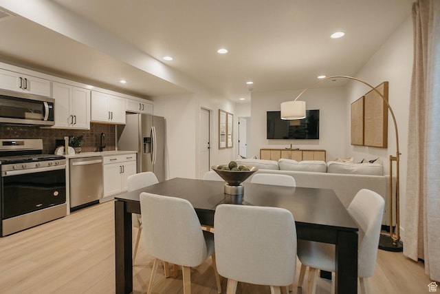 dining space featuring light wood-style floors and recessed lighting