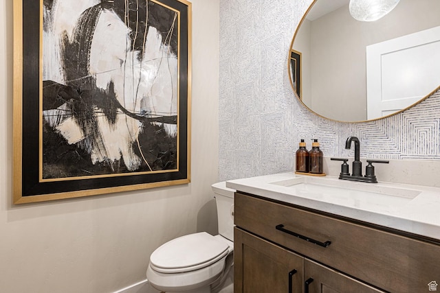 bathroom with toilet and vanity