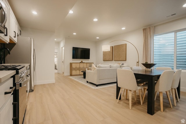 dining area featuring light wood-type flooring, recessed lighting, and baseboards