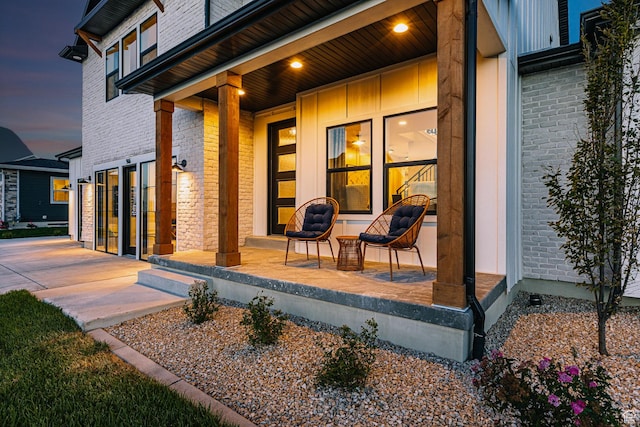 view of patio featuring covered porch and a garage