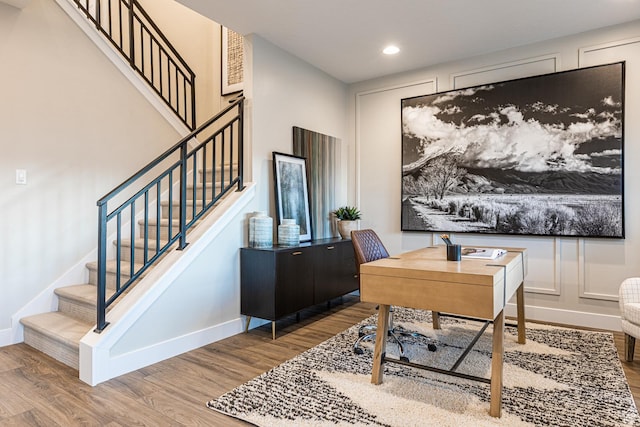 office featuring wood finished floors, baseboards, and recessed lighting