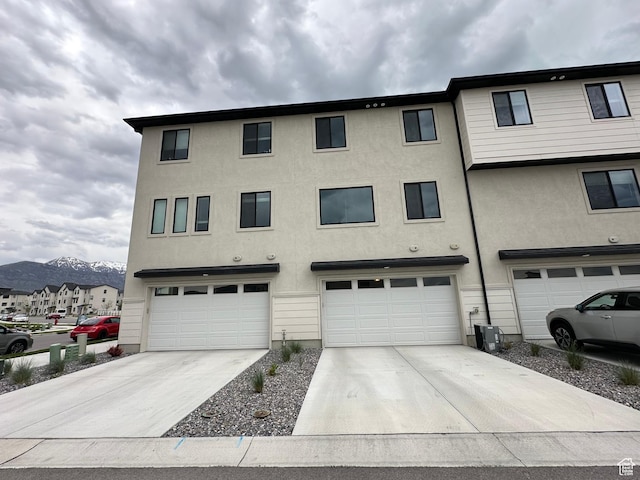 568 S 900 W, American Fork, UT 84003 - view of front of property with an attached garage, concrete driveway, stucco siding, and a mountain view