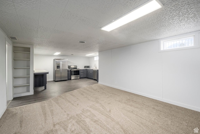 547 N 650 E, Orem, UT 84097 - unfurnished living room with carpet flooring, a textured ceiling, baseboards, and wood finished floors