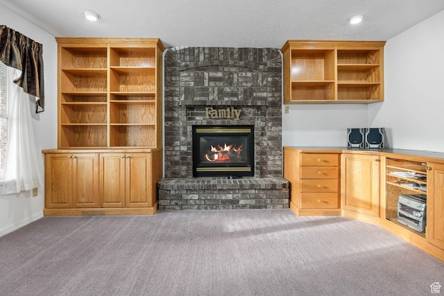 unfurnished living room featuring a fireplace, carpet flooring, and recessed lighting