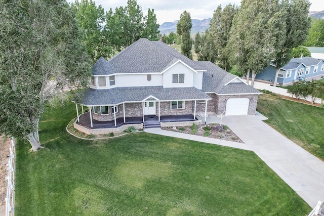 view of front of house featuring covered porch, a shingled roof, a garage, a front lawn, and concrete driveway