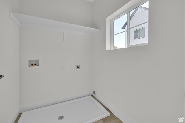 clothes washing area with electric dryer hookup, washer hookup, and baseboards