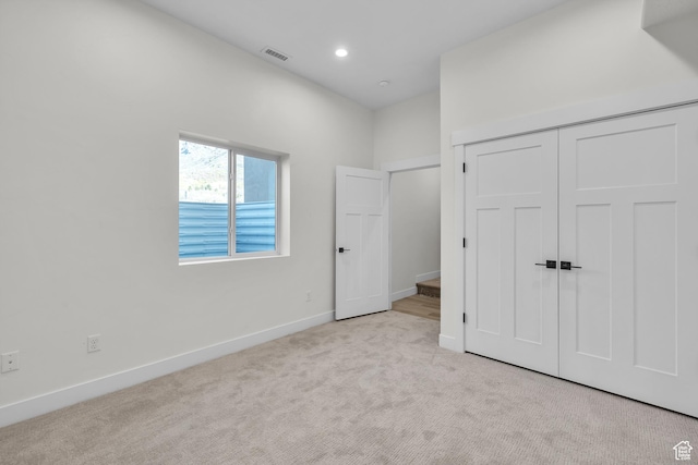 unfurnished bedroom with carpet floors, baseboards, a closet, and recessed lighting