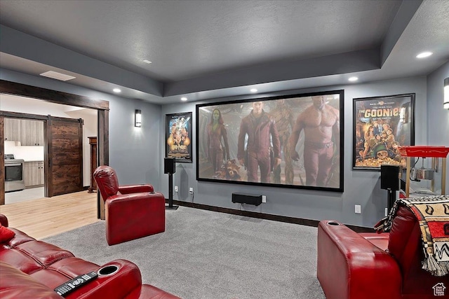 3749 N Eagle Ridge Dr E, Eden, UT 84310 - home theater featuring recessed lighting, baseboards, a barn door, a tray ceiling, and wood finished floors