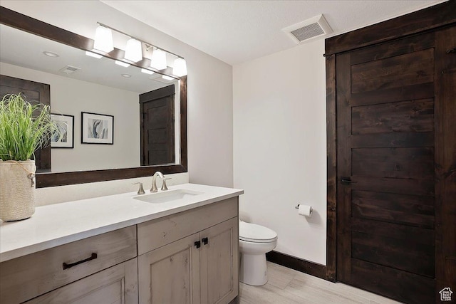 3749 N Eagle Ridge Dr E, Eden, UT 84310 - full bathroom with toilet, vanity, baseboards, and wood finished floors