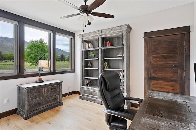 3749 N Eagle Ridge Dr E, Eden, UT 84310 - office space featuring a ceiling fan, baseboards, light wood finished floors, and a mountain view