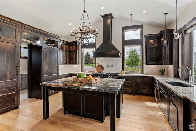 3749 N Eagle Ridge Dr E, Eden, UT 84310 - kitchen with a sink, premium range hood, healthy amount of natural light, dark stone counters, and vaulted ceiling
