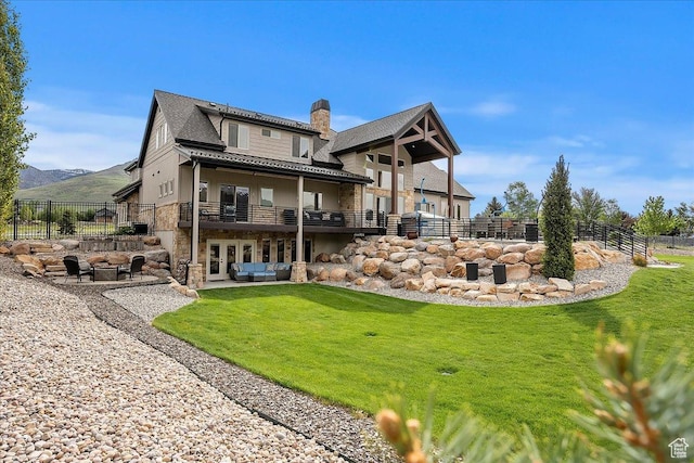 3749 N Eagle Ridge Dr E, Eden, UT 84310 - back of property with stone siding, a chimney, french doors, an outdoor hangout area, and a patio area