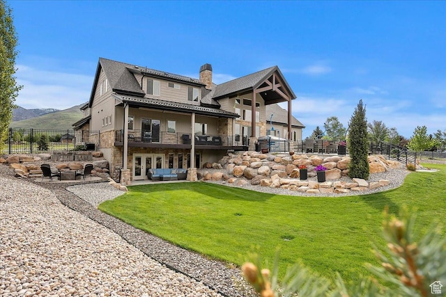 3749 N Eagle Ridge Dr E, Eden, UT 84310 - rear view of house featuring a chimney, stone siding, french doors, an outdoor hangout area, and a mountain view