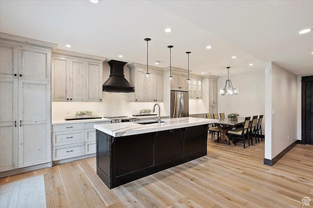 3749 N Eagle Ridge Dr E, Eden, UT 84310 - kitchen with stainless steel fridge, a sink, custom exhaust hood, recessed lighting, and light wood-type flooring
