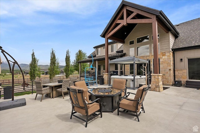 3749 N Eagle Ridge Dr E, Eden, UT 84310 - view of patio with a fire pit, fence, a mountain view, and a hot tub
