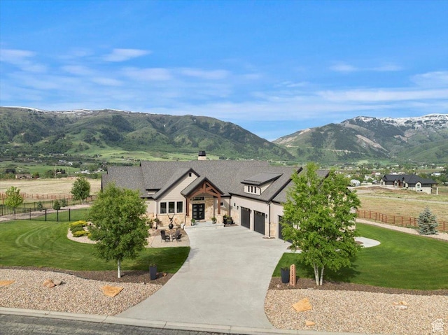 3749 N Eagle Ridge Dr E, Eden, UT 84310 - view of front of house featuring a mountain view, driveway, an attached garage, and stone siding