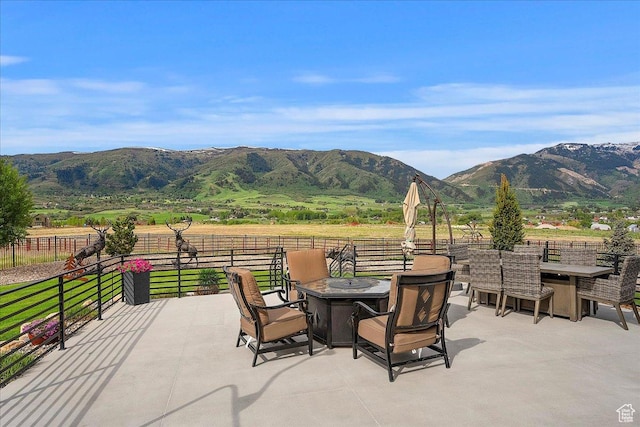 3749 N Eagle Ridge Dr E, Eden, UT 84310 - view of patio with an outdoor fire pit, a mountain view, and fence