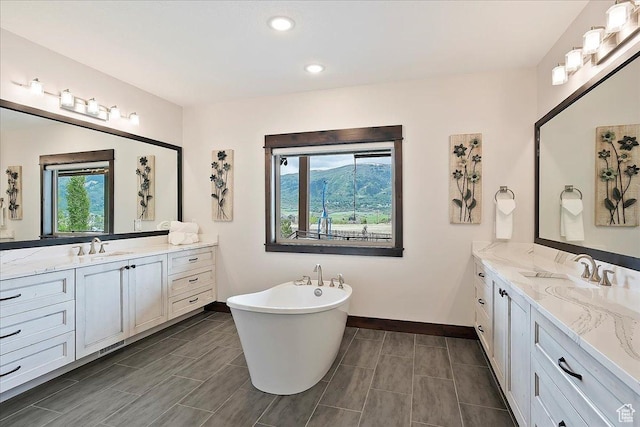 3749 N Eagle Ridge Dr E, Eden, UT 84310 - full bathroom featuring baseboards, two vanities, a freestanding bath, and recessed lighting