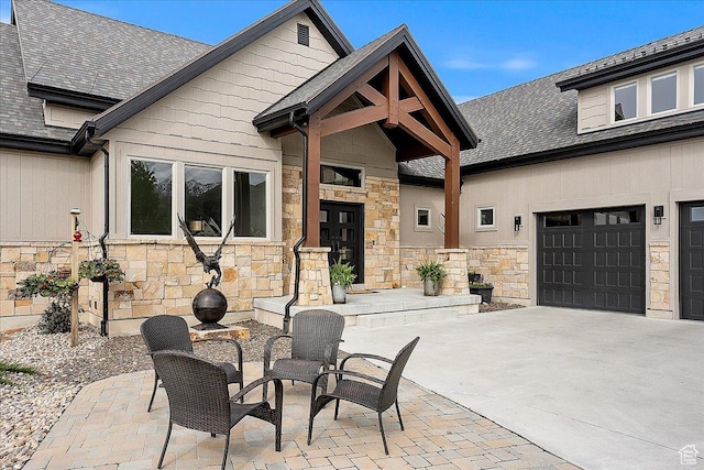 3749 N Eagle Ridge Dr E, Eden, UT 84310 - view of patio featuring driveway and a garage