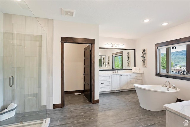 3749 N Eagle Ridge Dr E, Eden, UT 84310 - bathroom featuring a shower stall, vanity, a soaking tub, and recessed lighting