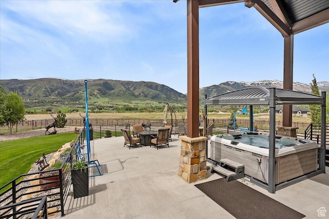 3749 N Eagle Ridge Dr E, Eden, UT 84310 - view of patio / terrace featuring a hot tub, a mountain view, and fence