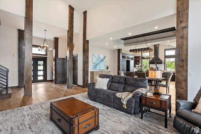 3749 N Eagle Ridge Dr E, Eden, UT 84310 - living area with a chandelier, wood finished floors, plenty of natural light, stairway, and a towering ceiling