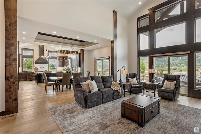3749 N Eagle Ridge Dr E, Eden, UT 84310 - living room featuring light wood-style flooring, healthy amount of natural light, a high ceiling, a tray ceiling, and recessed lighting