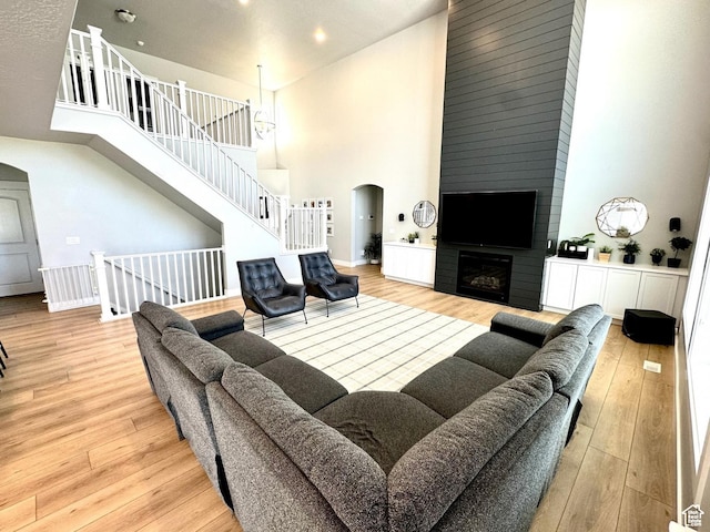 3146 W 1280 N, Provo, UT 84601 - living room featuring a high ceiling, arched walkways, wood finished floors, a large fireplace, and recessed lighting