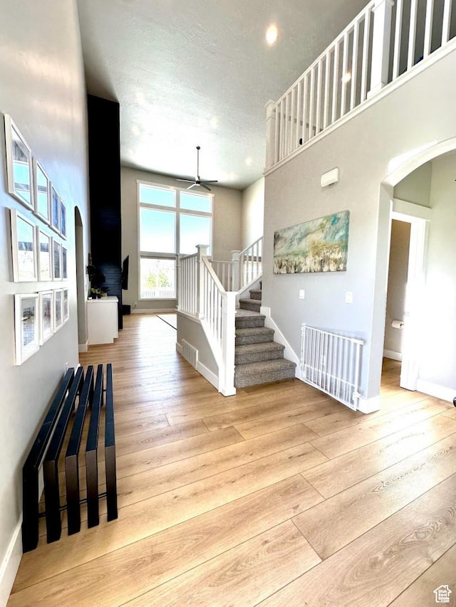 3146 W 1280 N, Provo, UT 84601 - foyer entrance featuring arched walkways, ceiling fan, wood-type flooring, stairs, and a textured ceiling