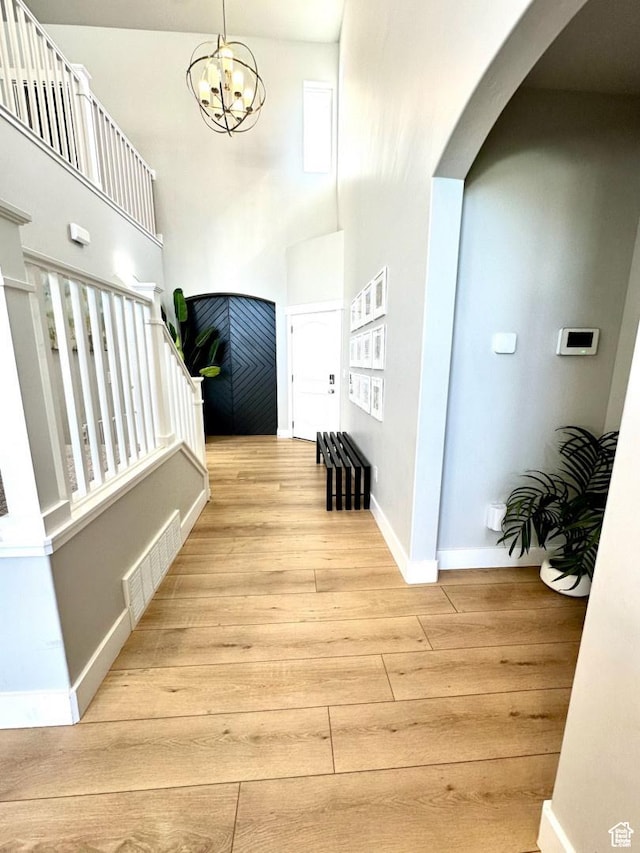 3146 W 1280 N, Provo, UT 84601 - entryway with wood finished floors, arched walkways, baseboards, a high ceiling, and a chandelier