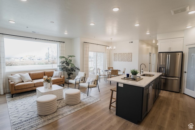 kitchen featuring appliances with stainless steel finishes, a sink, plenty of natural light, a chandelier, and recessed lighting