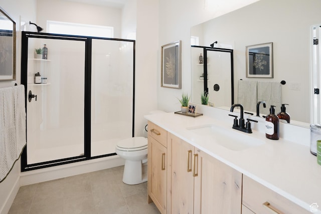full bath with a stall shower, toilet, vanity, and tile patterned floors