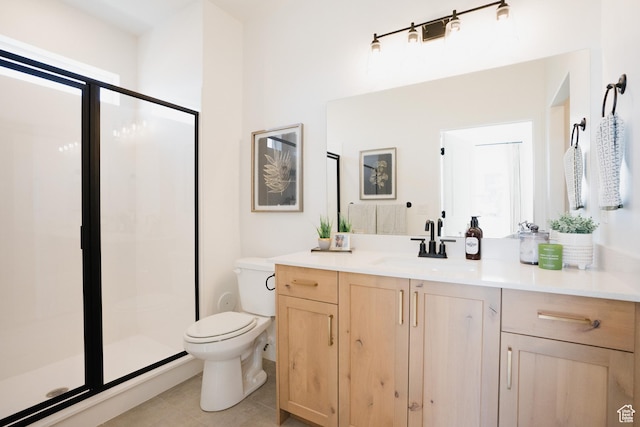 bathroom with toilet, a shower stall, vanity, and tile patterned floors