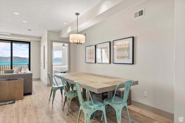 dining room with light wood-style floors, baseboards, and recessed lighting