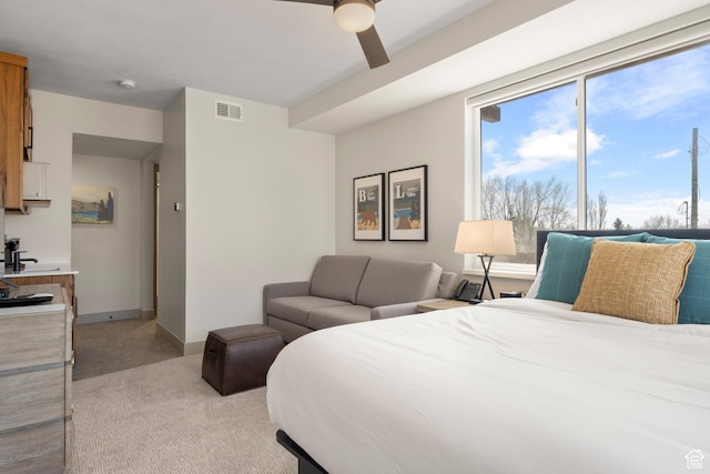 bedroom with light carpet, a ceiling fan, and baseboards