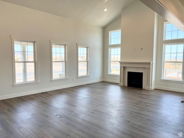 11121 S Bingham Rim Rd W Unit 5-425, South Jordan, UT 84009 - unfurnished living room with high vaulted ceiling, a brick fireplace, and dark wood finished floors