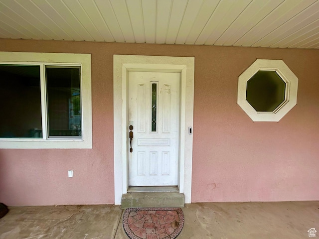 property entrance with stucco siding