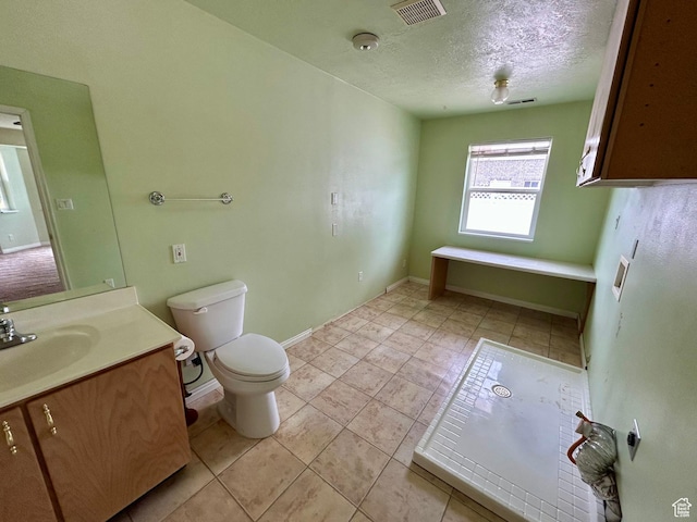 full bathroom with toilet, vanity, a textured ceiling, tile patterned flooring, and baseboards