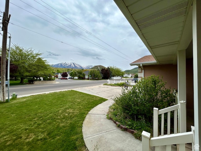 view of green lawn with a mountain view